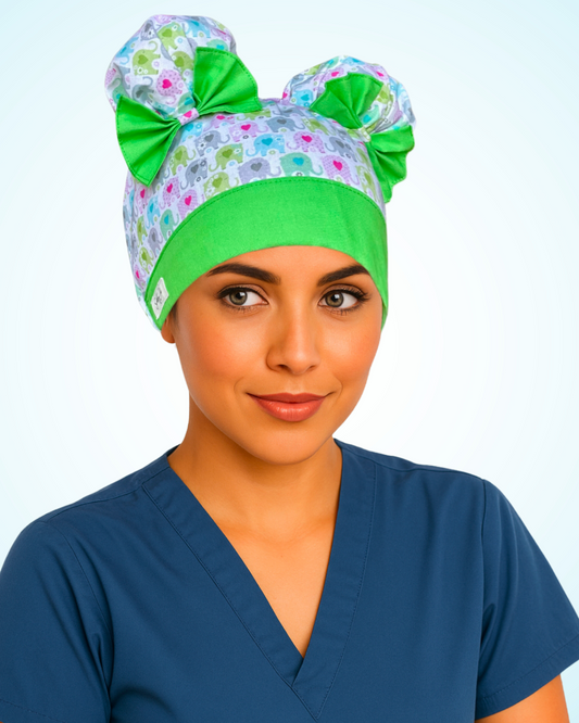 ScruBunz scrub cap with two space buns, pastel elephants, and green trim