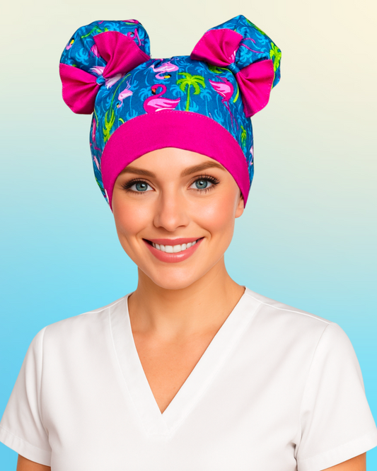 Nurse wearing Flamingo Island ScruBunz with tropical flamingo and palm tree print on blue background