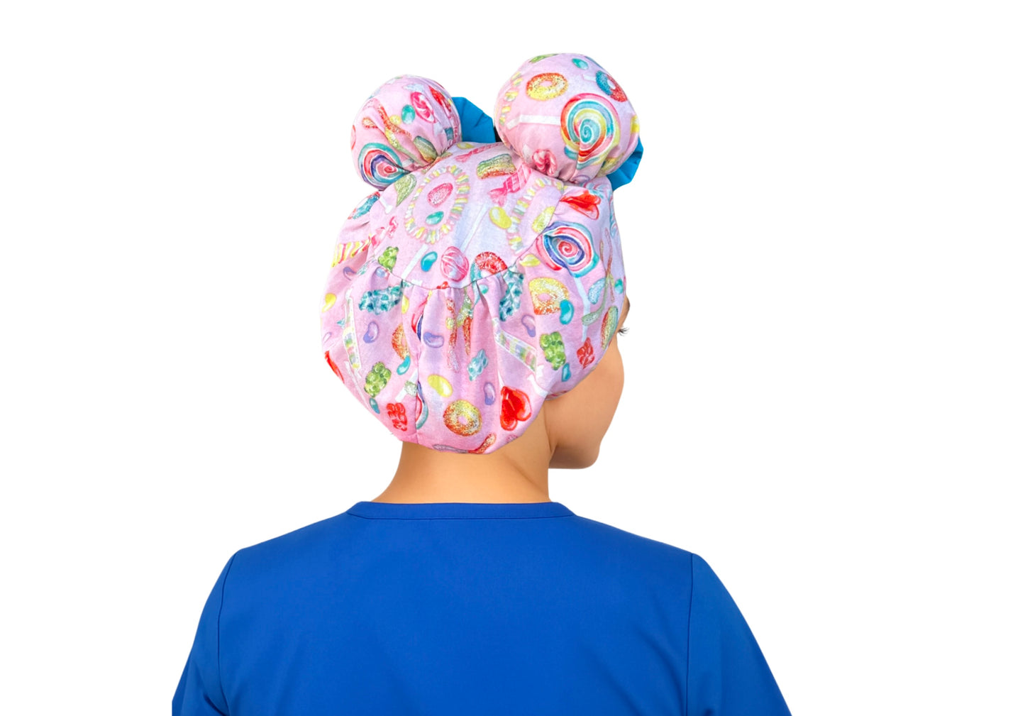 Back view of Sugar Pop ScruBunz showing two space buns, pink fabric with colorful candy print, and sky blue accent trim