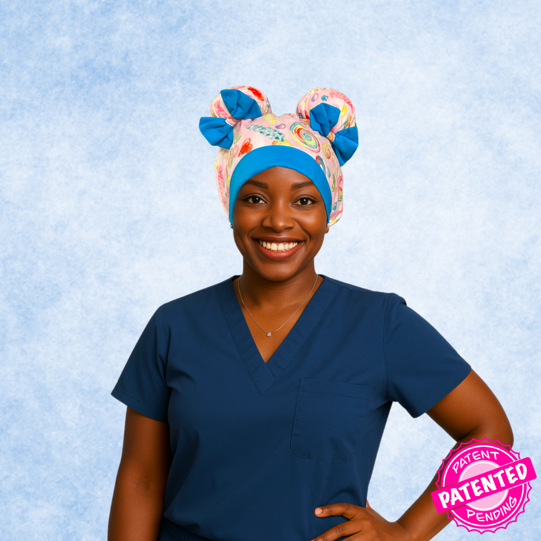 Nurse wearing Sugar Pop ScruBunz with two space buns, pink background, colorful candy design, and sky blue accents