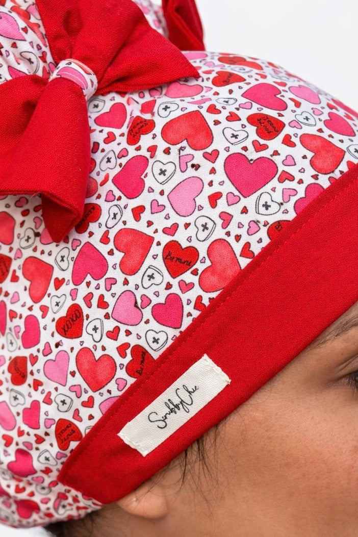 Heart Print Scrub Cap – Double Bun ScruBunz | Cute Girly Nurse Hat with Red Bows, Handmade Surgical Cap, OR Cap for Women
