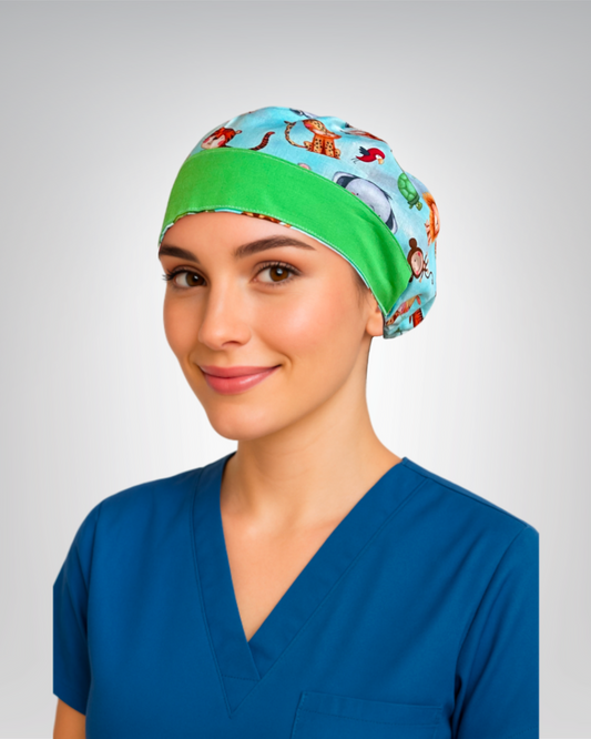 European style scrub cap with blue background with white clouds and playful safari animals like lions, tigers, and elephants, with green trim