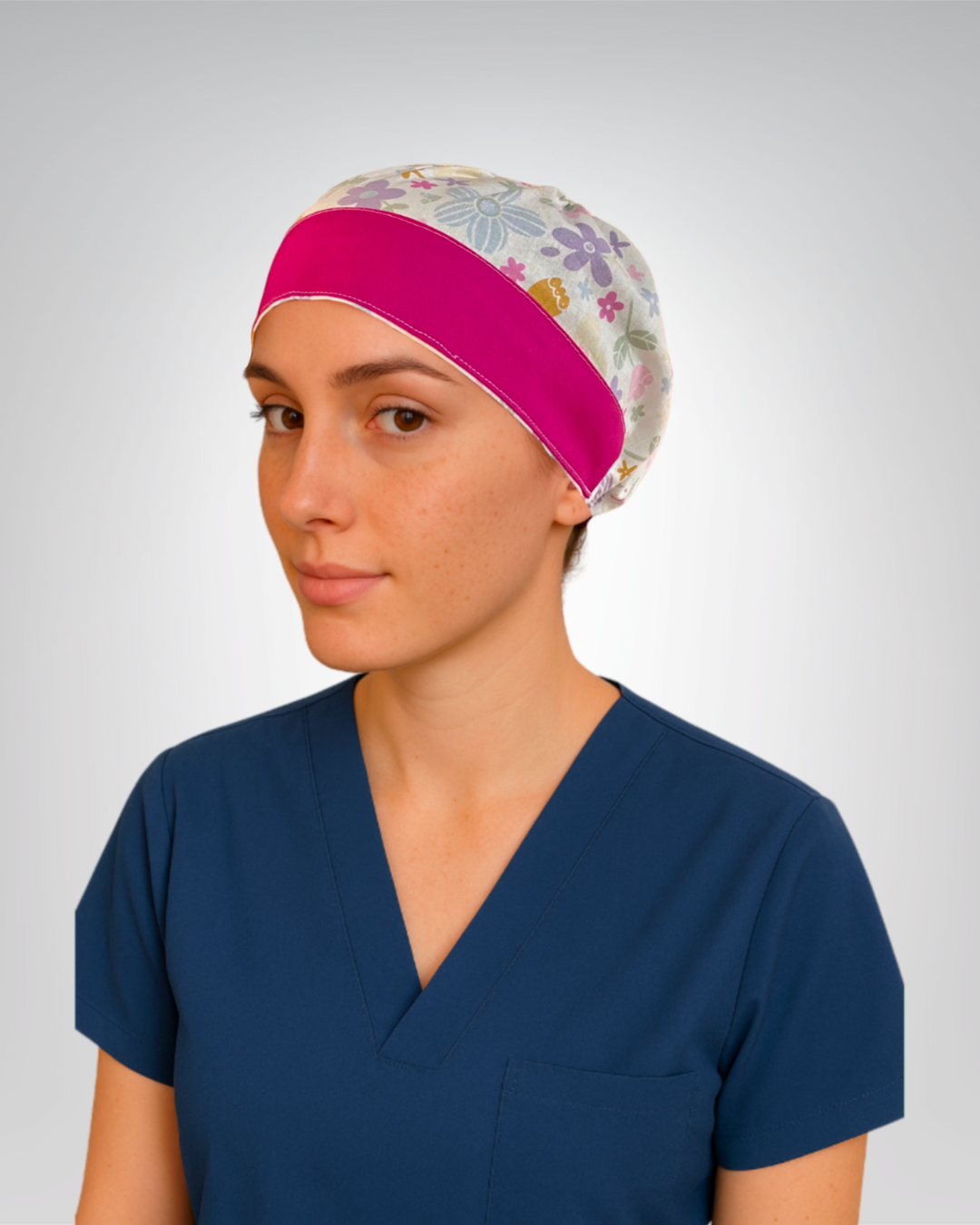 European style cotton scrub cap with white base, and purple, blue, pink, and yellow flowers with fuchsia accents