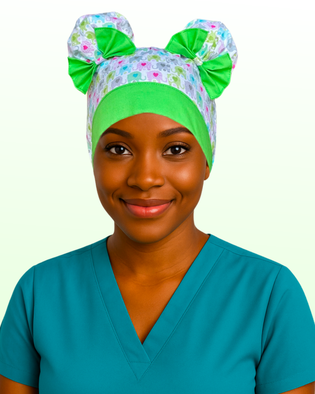 Nurse wearing Ele-Fun Parade ScruBunz with pastel elephants, green trim, and signature double space buns