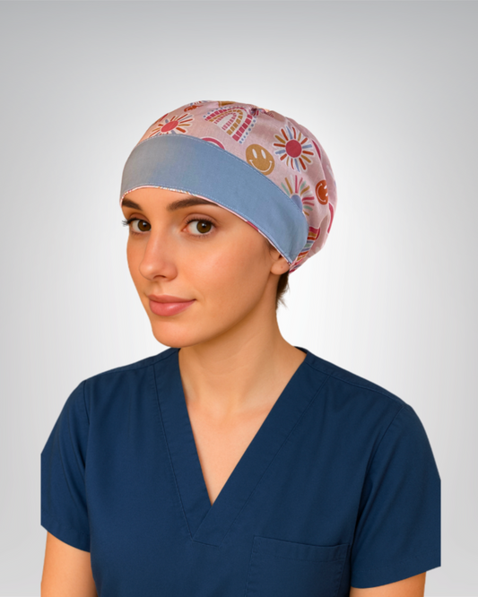 European style traditional scrub cap, light pink background, and boho rainbows and sunshines in orange, periwinkle, and gold
